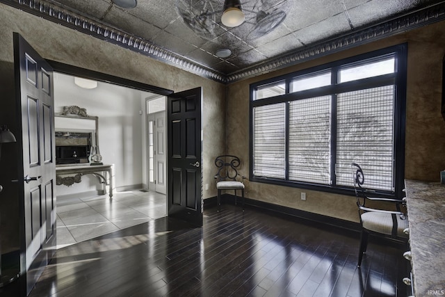 empty room featuring crown molding and wood-type flooring