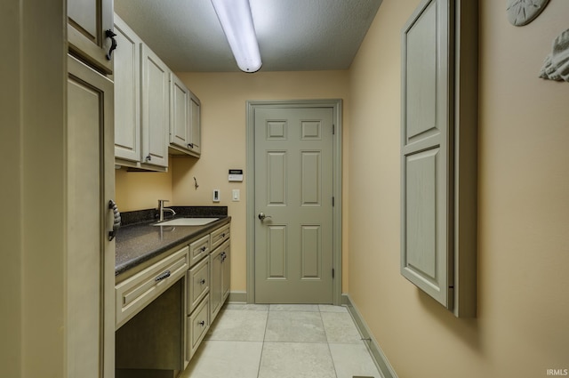 kitchen with light tile patterned floors and sink