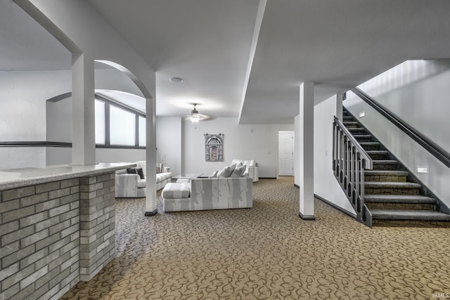 carpeted living room with ceiling fan