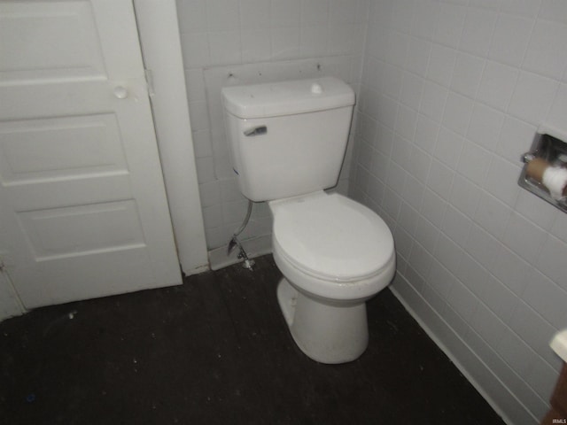 bathroom featuring wood-type flooring, tile walls, and toilet