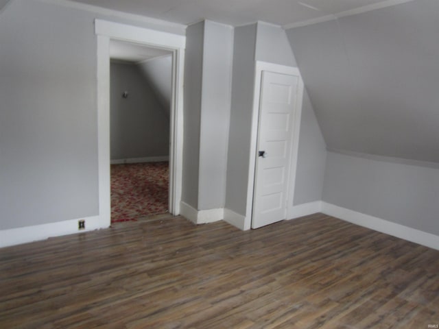 bonus room with lofted ceiling and dark wood-type flooring