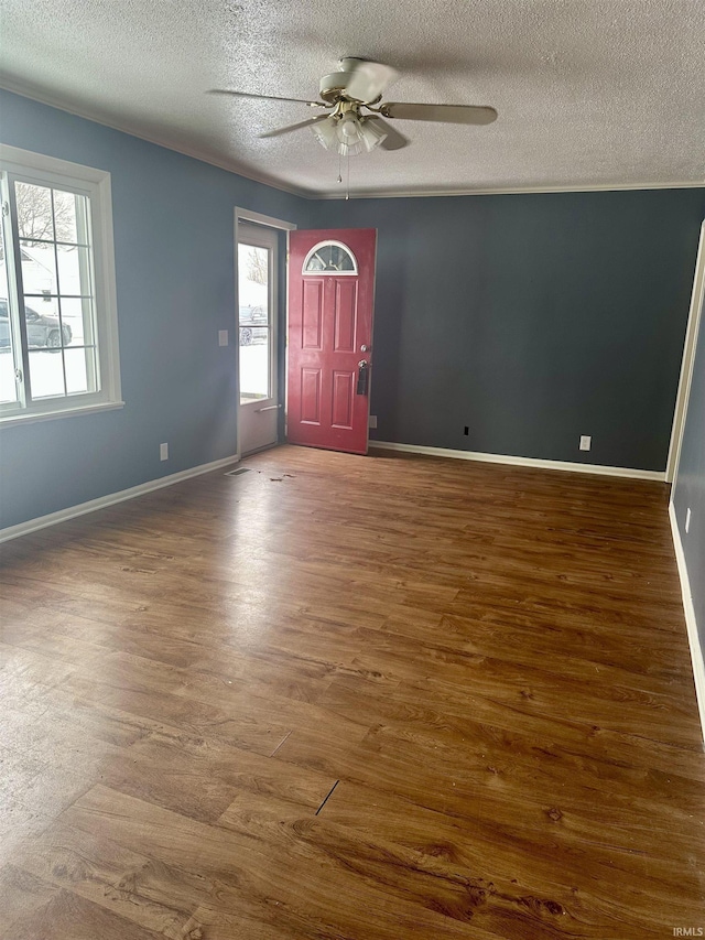 foyer with hardwood / wood-style floors, a textured ceiling, and ceiling fan