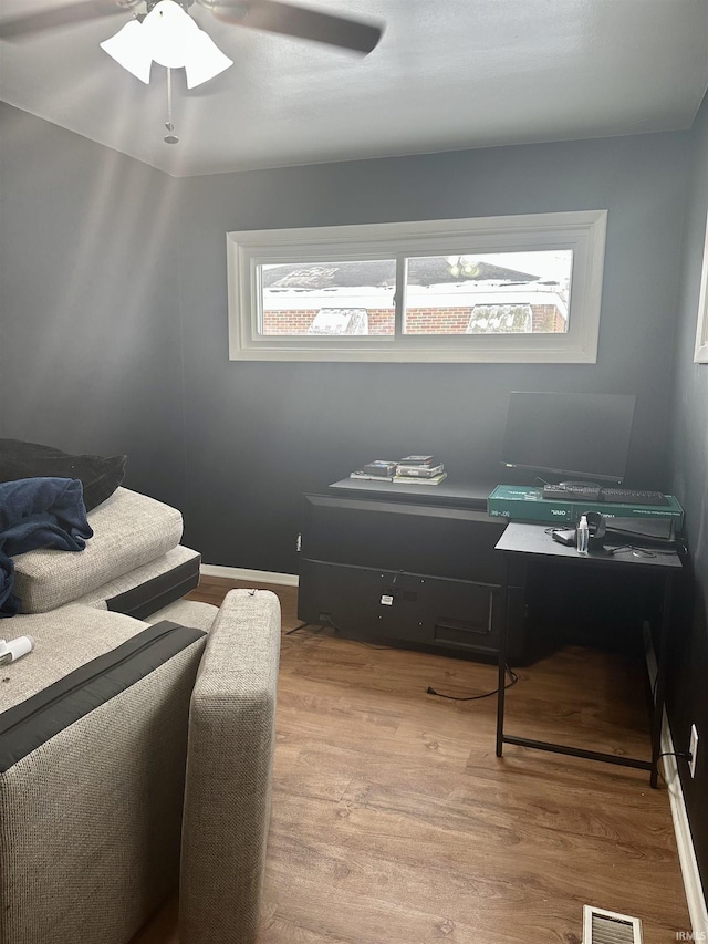 bedroom featuring light wood-type flooring and ceiling fan