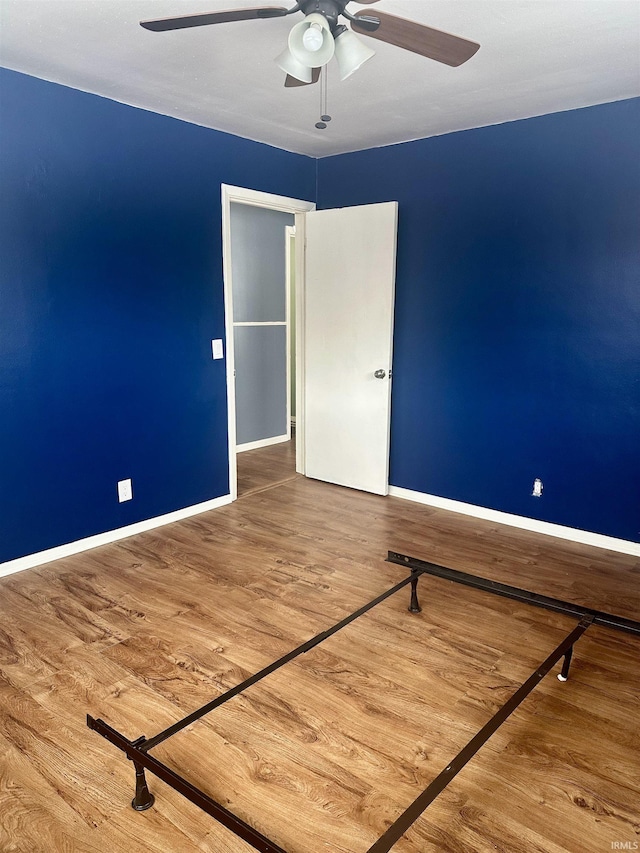 unfurnished bedroom featuring ceiling fan and hardwood / wood-style floors