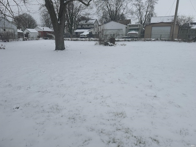 yard covered in snow with a garage