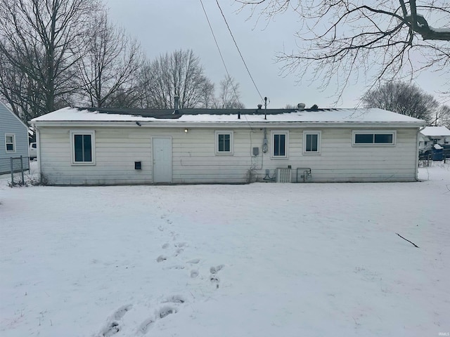 view of snow covered back of property