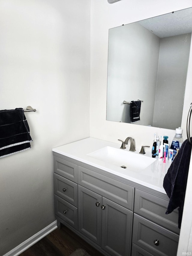 bathroom with hardwood / wood-style floors and vanity