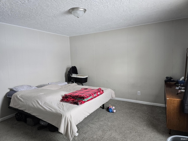 carpeted bedroom featuring a textured ceiling and wooden walls