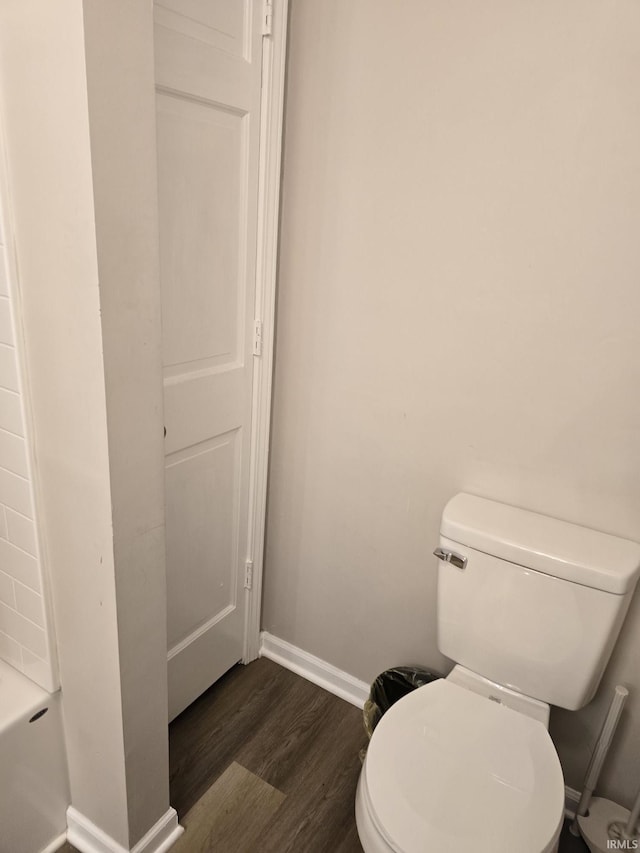 bathroom with hardwood / wood-style flooring and toilet