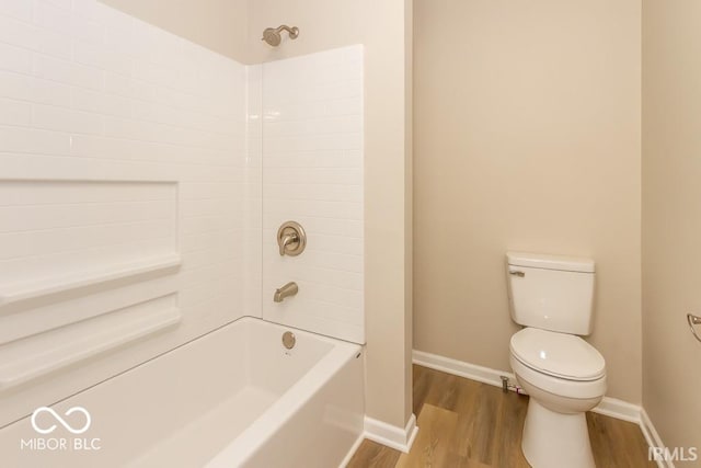 bathroom with hardwood / wood-style flooring, toilet, and shower / bathtub combination