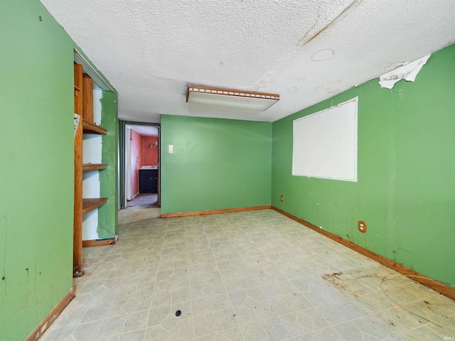 unfurnished room with a textured ceiling