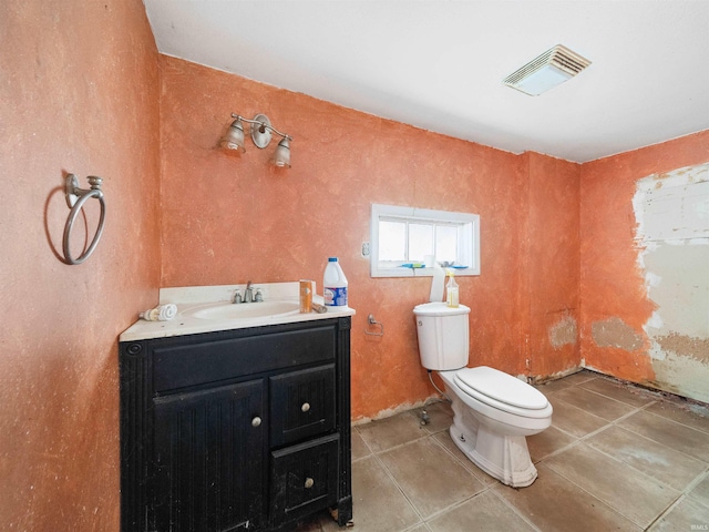 bathroom featuring tile patterned floors, vanity, and toilet