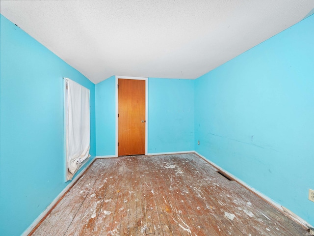 interior space featuring hardwood / wood-style floors and lofted ceiling