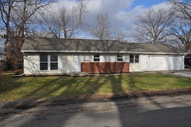 single story home featuring a garage and a front lawn