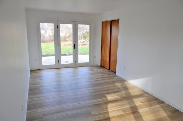 unfurnished room with light wood-type flooring