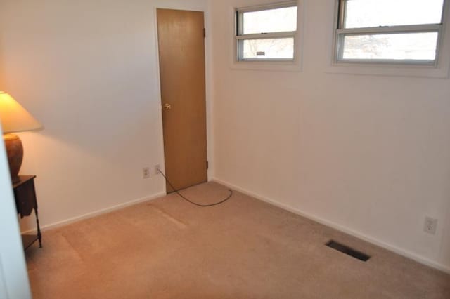 spare room with light colored carpet