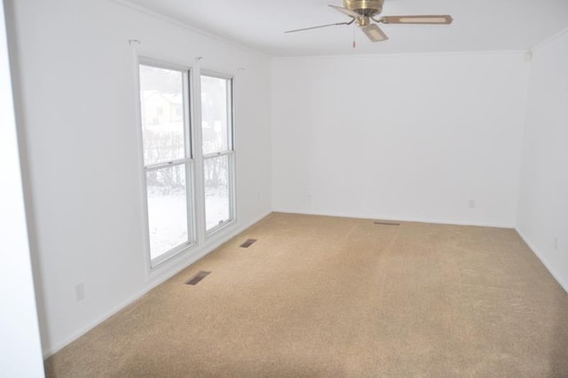 unfurnished room with ceiling fan and carpet