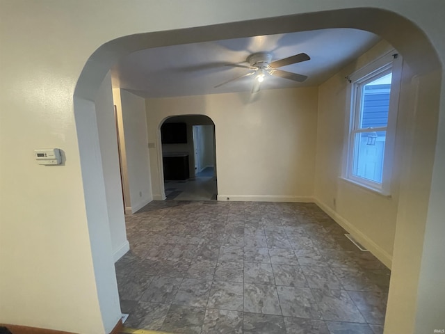 unfurnished room with ceiling fan