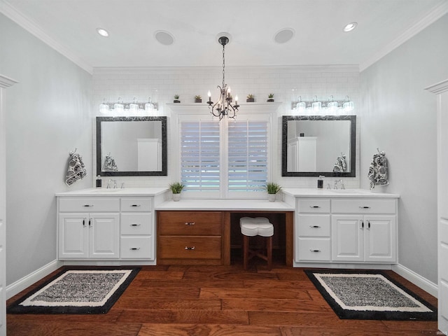 bathroom featuring a chandelier, vanity, wood-type flooring, and ornamental molding