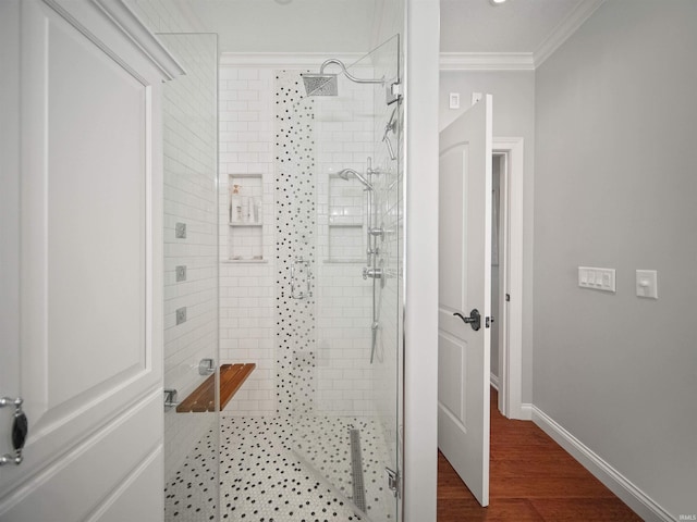 bathroom featuring crown molding, a shower with shower door, and wood-type flooring