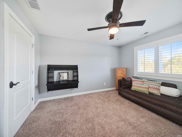 living room featuring carpet flooring and ceiling fan