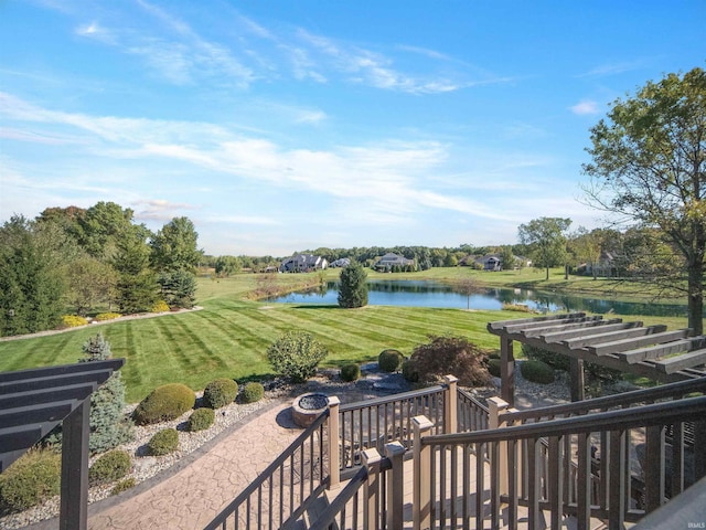 surrounding community with a water view, a patio area, and a lawn