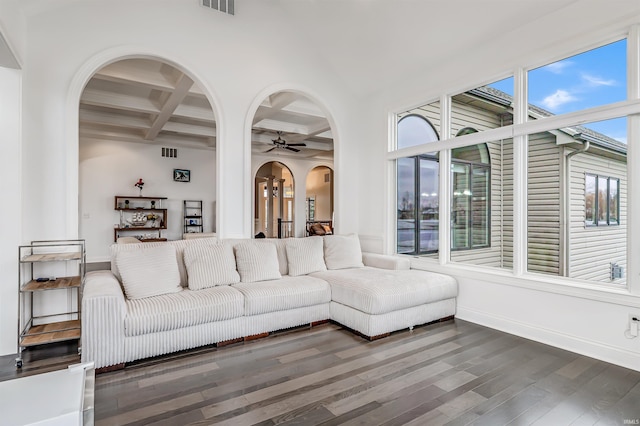 unfurnished living room with ceiling fan, beamed ceiling, dark hardwood / wood-style floors, and coffered ceiling