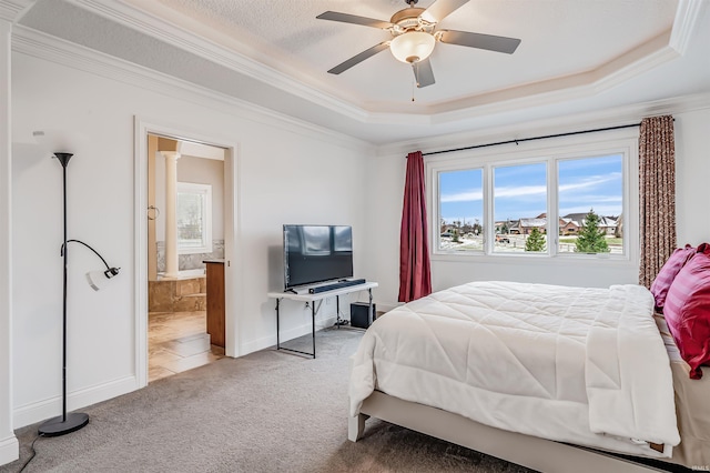 carpeted bedroom featuring a tray ceiling, ceiling fan, crown molding, and a textured ceiling