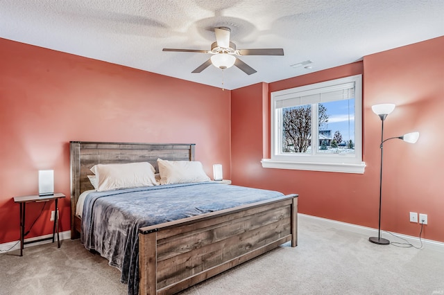 bedroom with carpet, ceiling fan, and a textured ceiling