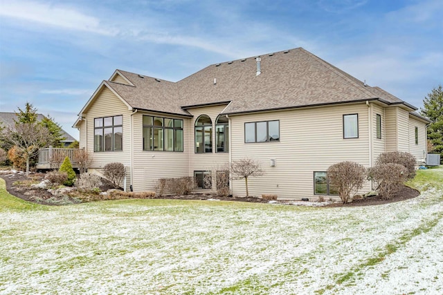 rear view of property with a yard and a wooden deck