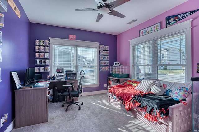 carpeted office space featuring ceiling fan