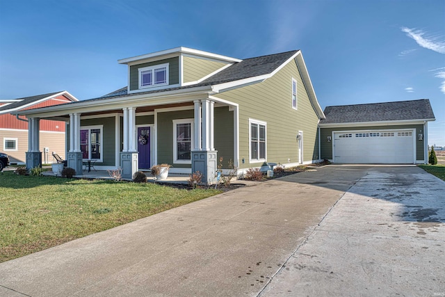 view of front of house with covered porch, a garage, and a front lawn