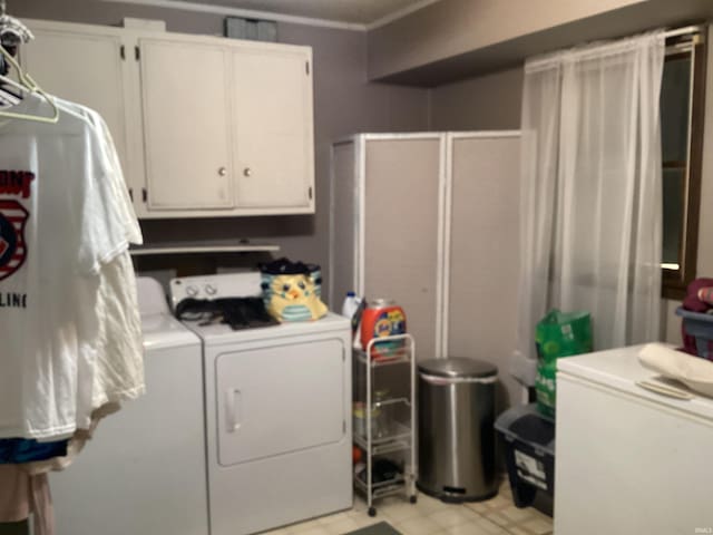 laundry area featuring washer and dryer and cabinets