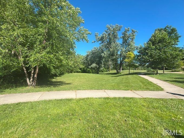 view of property's community with a lawn