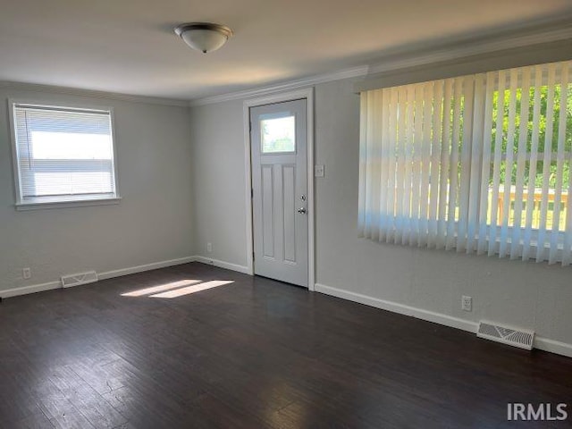 entryway with dark hardwood / wood-style floors and crown molding