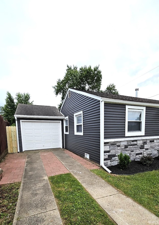 view of home's exterior featuring an outdoor structure and a garage