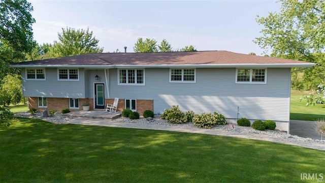 rear view of property with a lawn