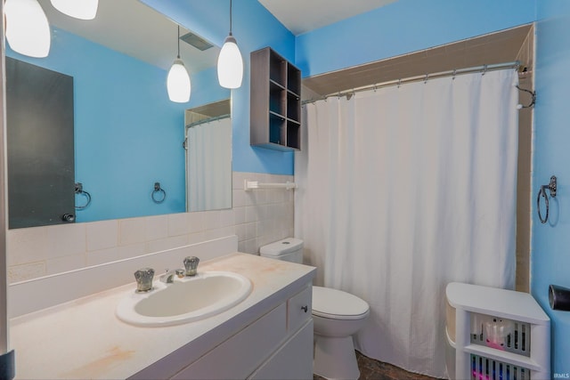 bathroom with vanity, tile walls, curtained shower, and toilet