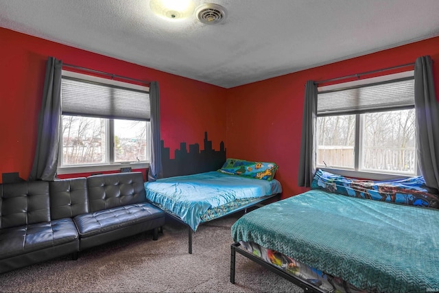 bedroom with carpet and a textured ceiling