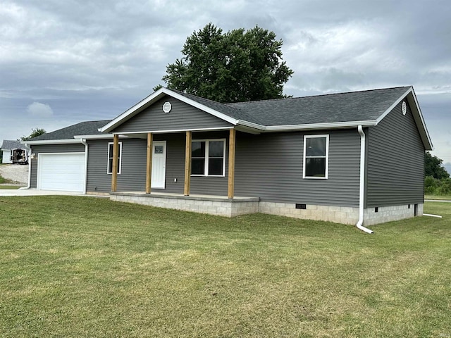 view of front of house with covered porch, a garage, and a front lawn