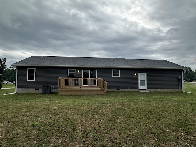 rear view of house featuring a yard, a deck, and central air condition unit