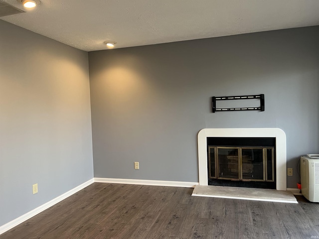 unfurnished living room featuring dark hardwood / wood-style floors