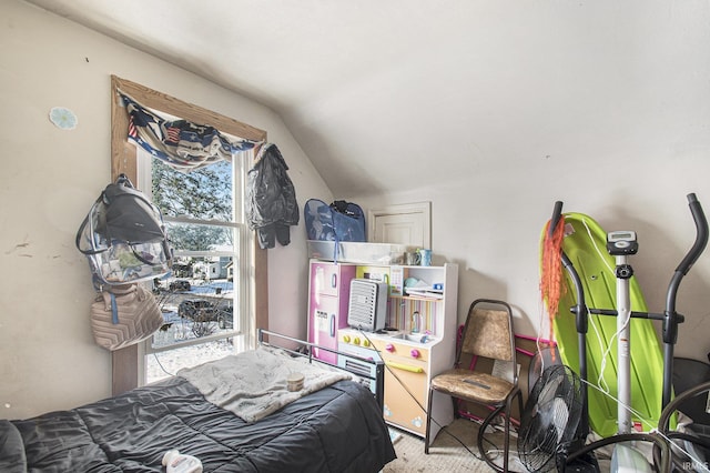 bedroom featuring light carpet and lofted ceiling