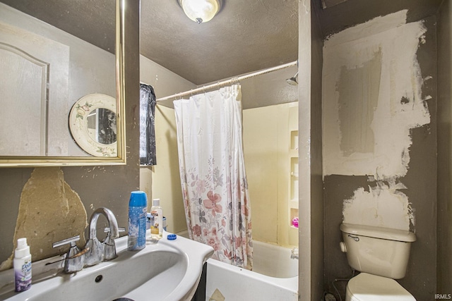 full bathroom featuring a textured ceiling, shower / bath combo, toilet, and sink