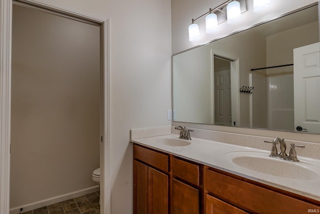 bathroom with vanity, toilet, and walk in shower