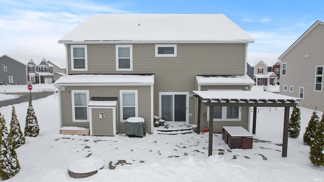 view of snow covered back of property