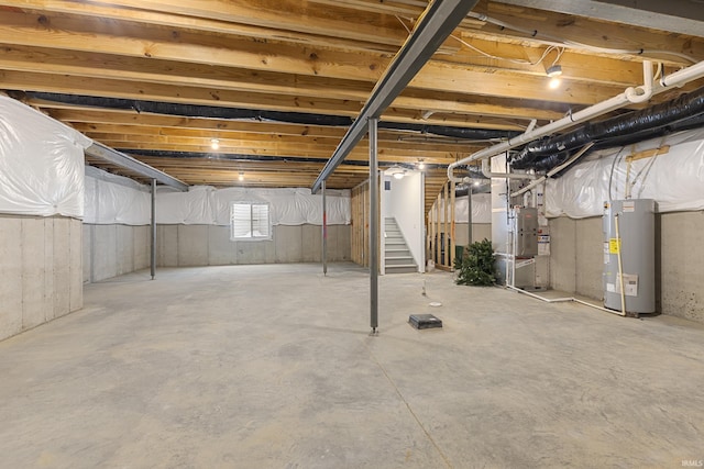 basement with water heater and stairs