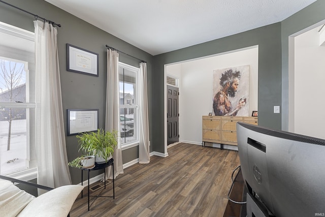 interior space featuring dark wood-style floors and baseboards