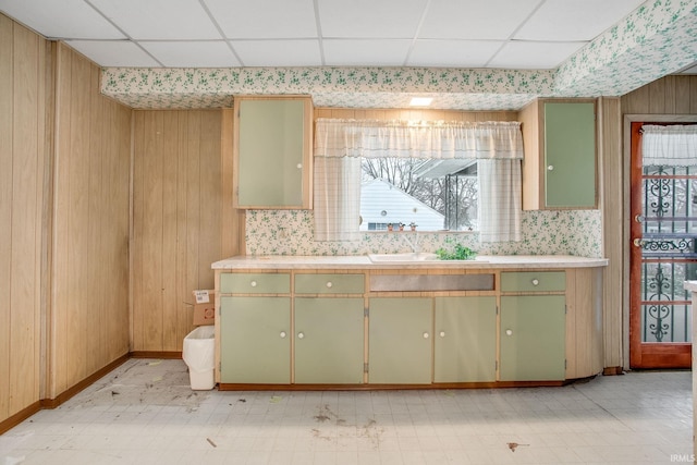 kitchen with a paneled ceiling, sink, and green cabinets