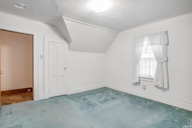 bonus room featuring carpet flooring, a textured ceiling, and vaulted ceiling